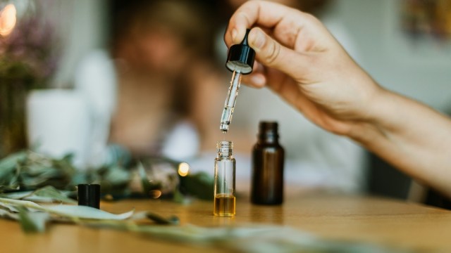 French aromatherapy words represented by someone using a dropper to mix scents in a tincture.
