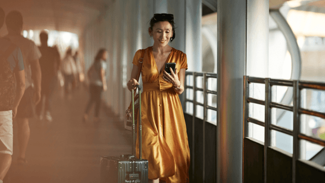 tips for travel represented by an image of a woman with a suitcase traveling