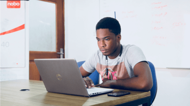 A man on his laptop taking a language proficiency exam