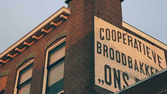 Dutch alphabet represented by a photo of a brick building in the Netherlands at sunset.