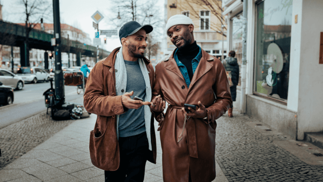 two men chatting as they walk down the street learn polari