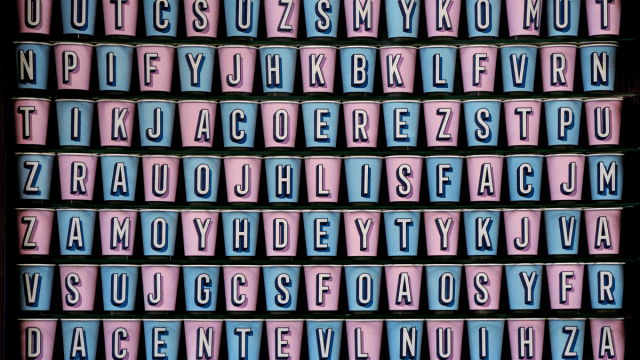 History of English spelling represented by a grid of pink and blue cups with letters on each of them.