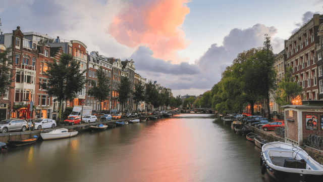 sunset over canal in amsterdam why learn dutch